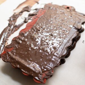 Cover the filling with another layer of dark chocolate.